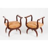 A pair of Louis Philippe faldstoolsSolid and veneered mahogany Textile upholstered seats Porcelain