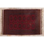 A Lahur rug, PakistanIn wool and cotton Geometric design in shades of burgundy (faults and signs