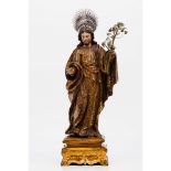 Saint JosephCarved, polychrome and gilt wooden sculpture Metal filigree lily and Indo-Portuguese