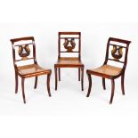 A set of three Empire chairsMahogany and other timbers Carved, pierced and part gilt swans