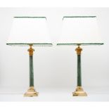 A pair of column lampsGreen stone columns Yellow metal base and capital Height: 90cm
