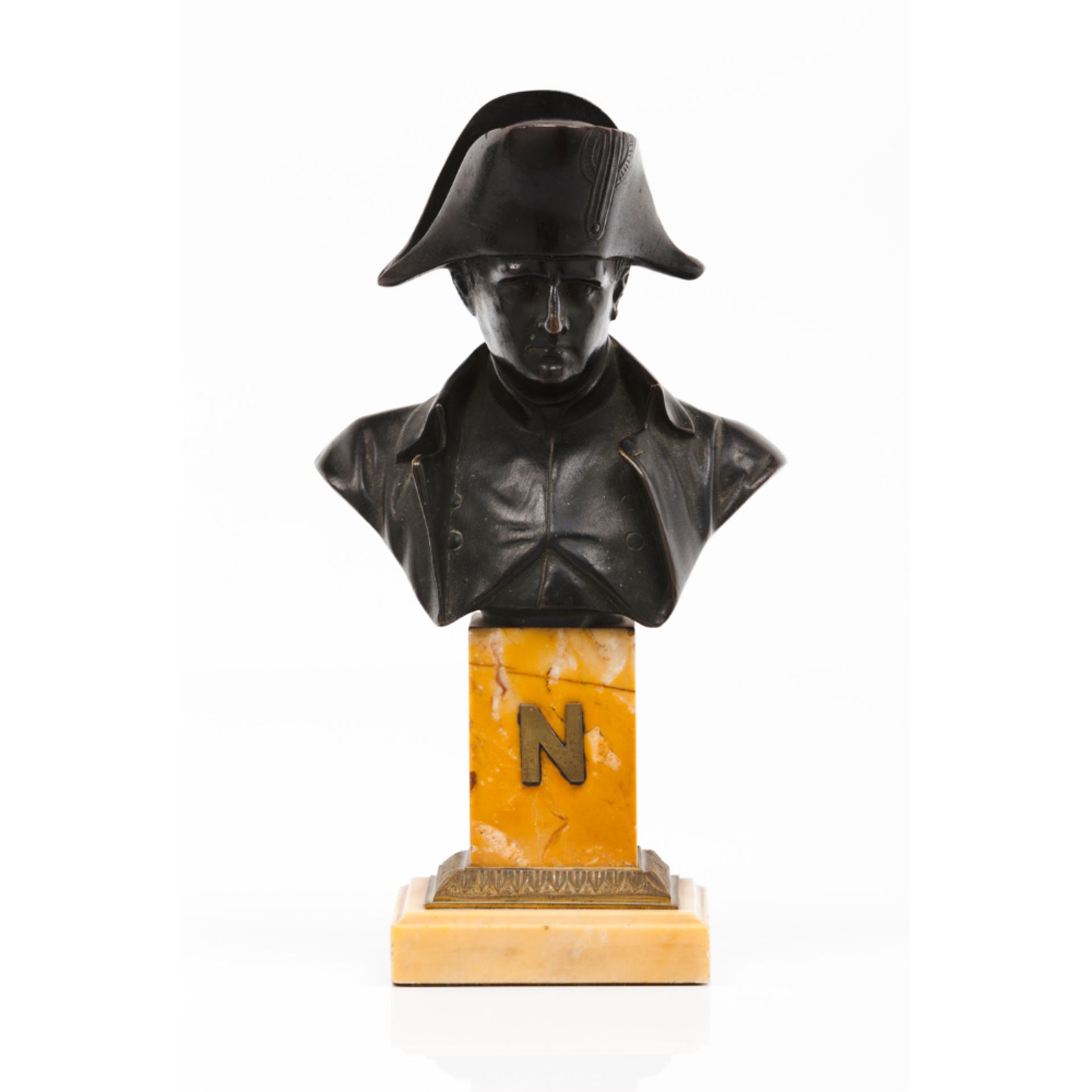 A bust of NapoleonPatinated bronze sculpture Marble stand with frieze and yellow metal "N" Signed "