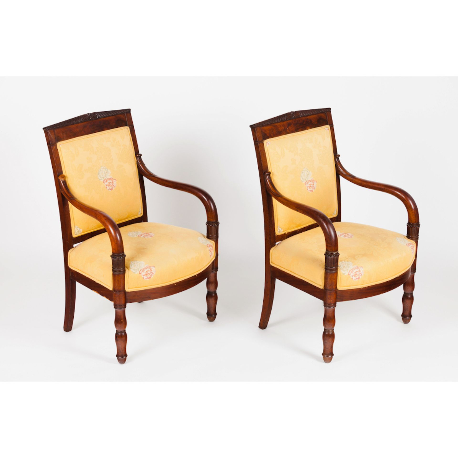 A pair of Louis Philippe fauteuilsMahogany and veneered Part carved decoration Textile upholstery