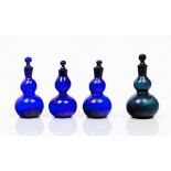 A group of four bottles and stoppersGourd-shaped transluced blue glass Reliefs and spiralled