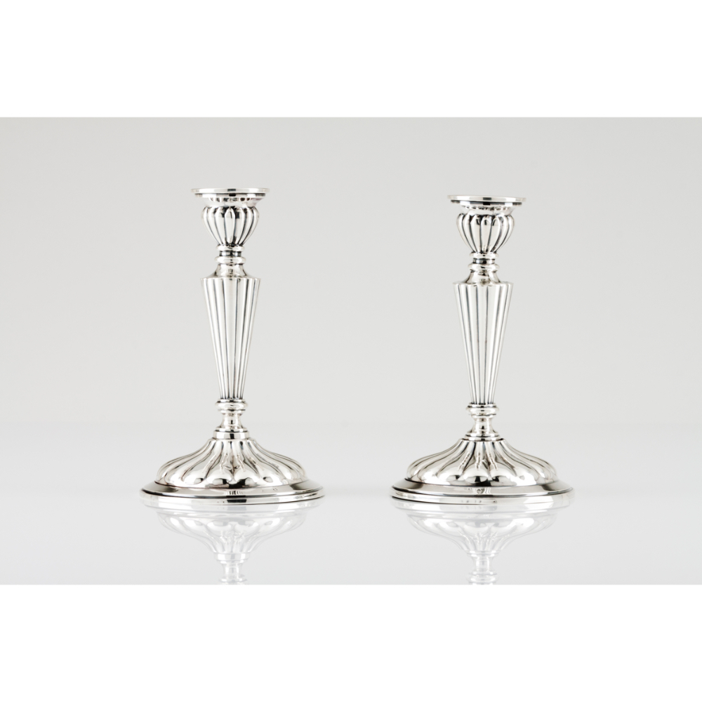 Four candlesticksSpanish silver, 20th century Fluted decoration Assay and same date maker's marks