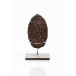 A powder flaskCoconut shell or large seed Profusely decorated with foliage motifs and hunting