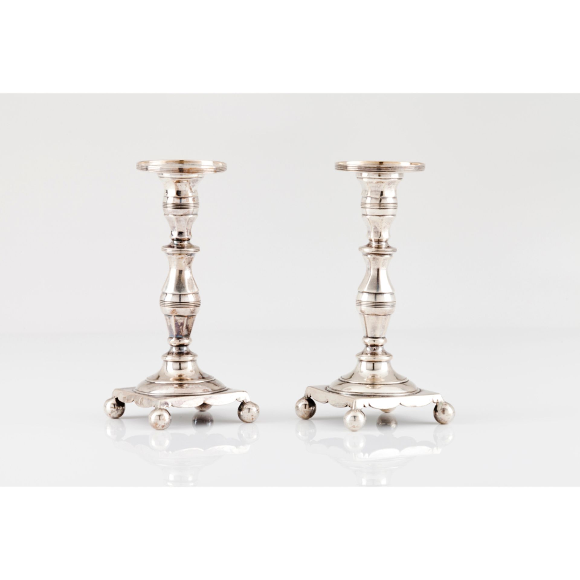 A pair of small candle sticksPortuguese silver, 19th century Turned and striated decoration On