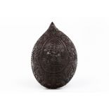 A coconut shellLow-relief decoration of foliage motifs, fantastic animals and central medallion with