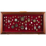 A suspending display cabinet with collection of various medalsInterior with religious medals