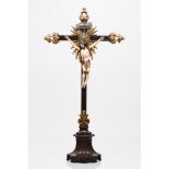 A crucified ChristIndo-Portuguese ivory sculpture Part polychrome decoration Rosewood cross and