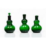 A group of three bottlesGourd-shaped green glass One with stopper Europe, 19th centuryHeight: 14 cm