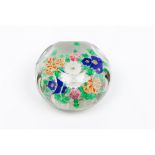 A paperweightFaceted glass paste Inner floral decoration 20th centuryDiam.: 8 cm
