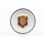 A plateFaience Yellow, green, blue, red and manganese decoration of central heraldic shield for