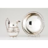 A ewer and basinPortuguese silver 19th century Basin of engraved and chiselled foliage band