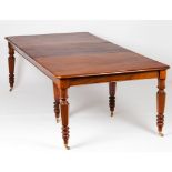 A Victorian style dining tableMahogany Faceted and turned legs of yellow metal terminals and castors