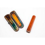 A set of two cigarette holdersAmber Metal ring to one and one cased (signs of wear)Length: 8 cm (