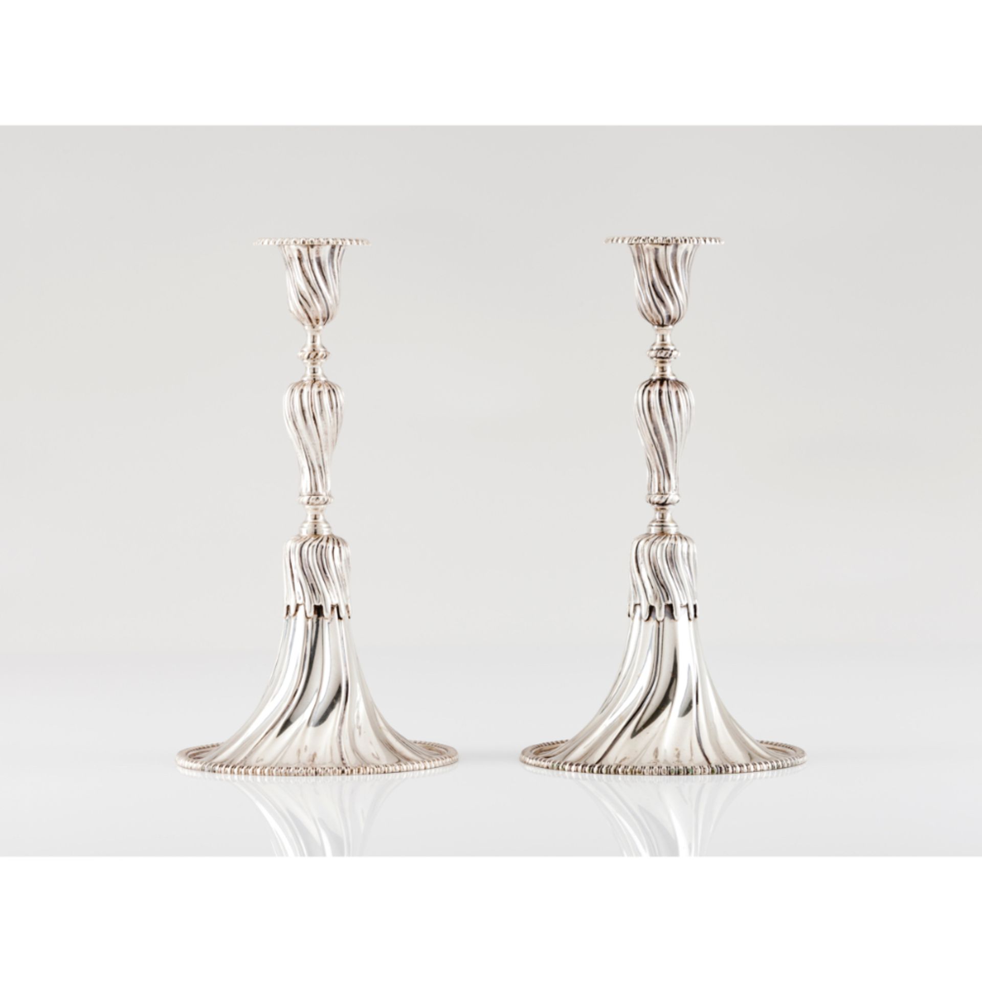 A pair of apron candle sticksPortuguese silver Spiralled decoration after 18th century prototype