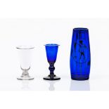 A group of three piecesTwo footed drinking glasses and a solitaire vase Blue and translucent glass