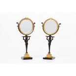 A pair of table top mirrorsPatinated and gilt bronze Caryatid shaped shafts Black marble stand