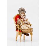 An enthroned Child JesusCarved and polychrome wooden figure Carved and gilt wooden chair Silver