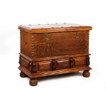 A large chestChestnut and other timbers Yellow metal hardware Three drawers to base Bun feet 20th