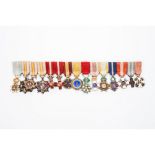 A group of insignias and miniaturesOrder of Military Merit medal of red badge; Civil Merit medal;