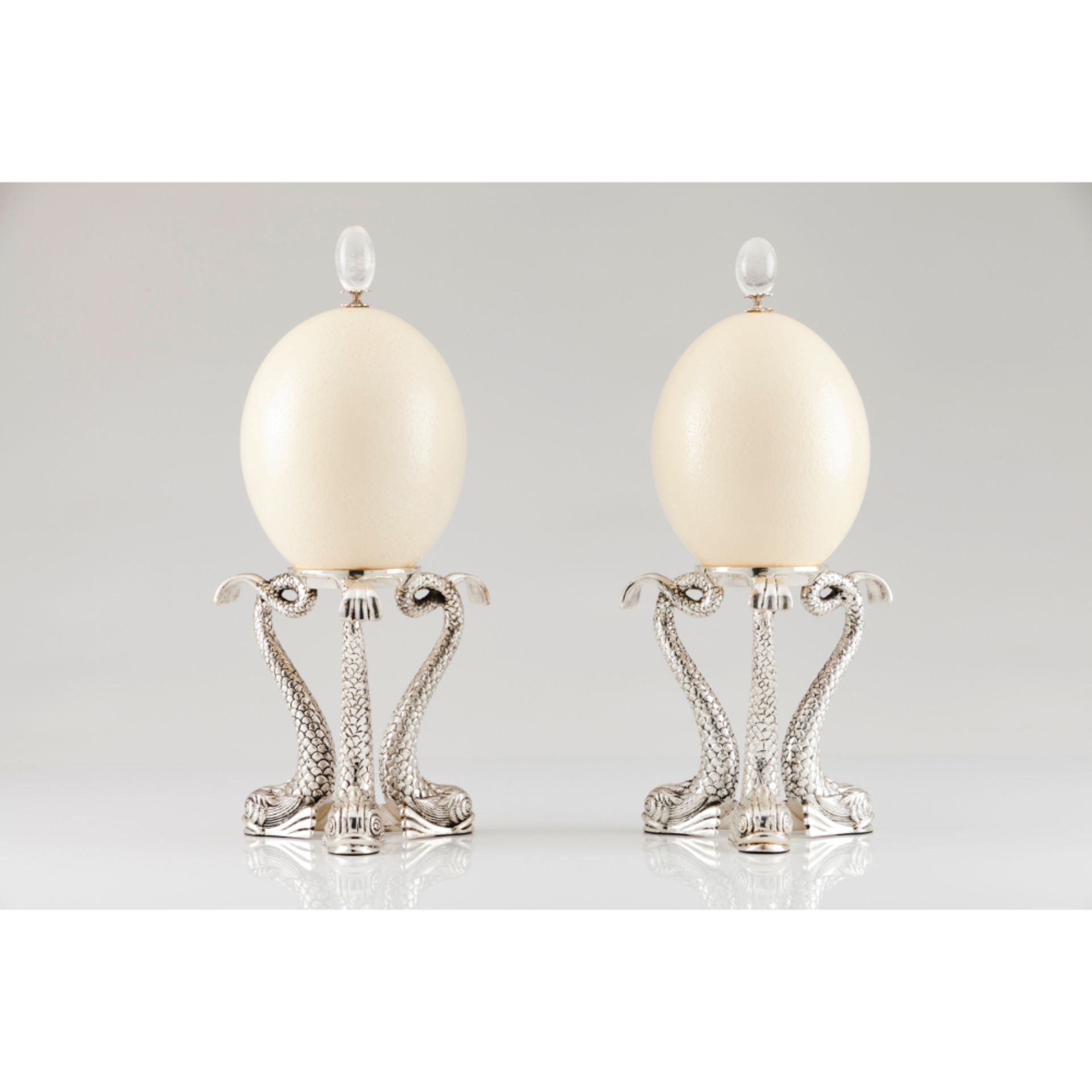 Two mounted ostrich eggs