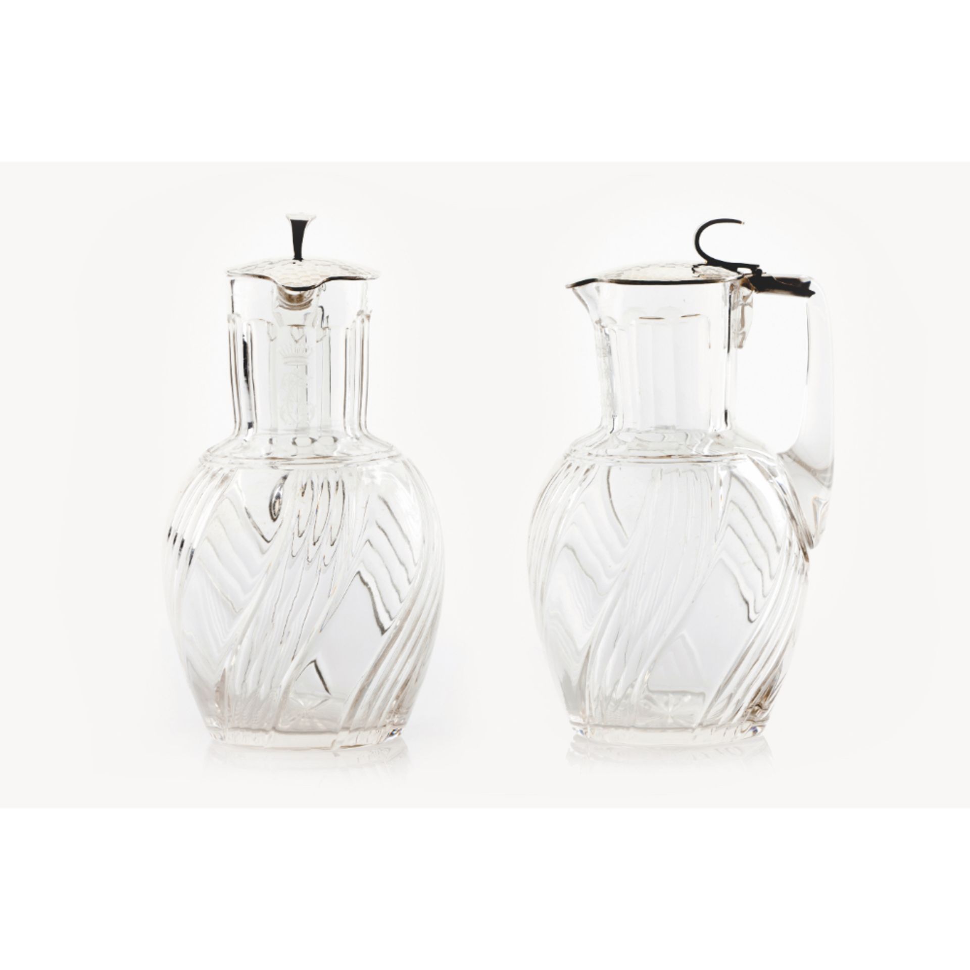 A pair of crystal and silver decanters