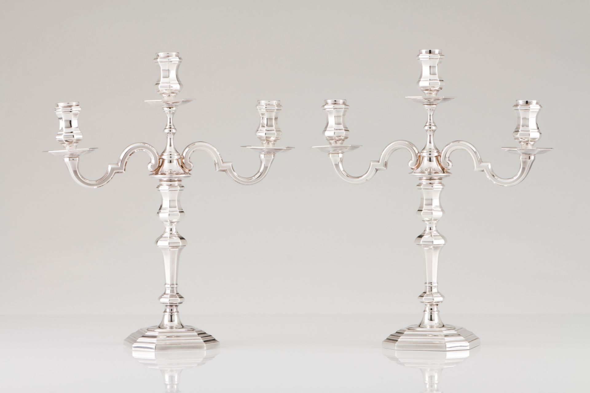 A pair of three branch candelabra