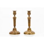 A pair of Louis XVI style candlesticks
