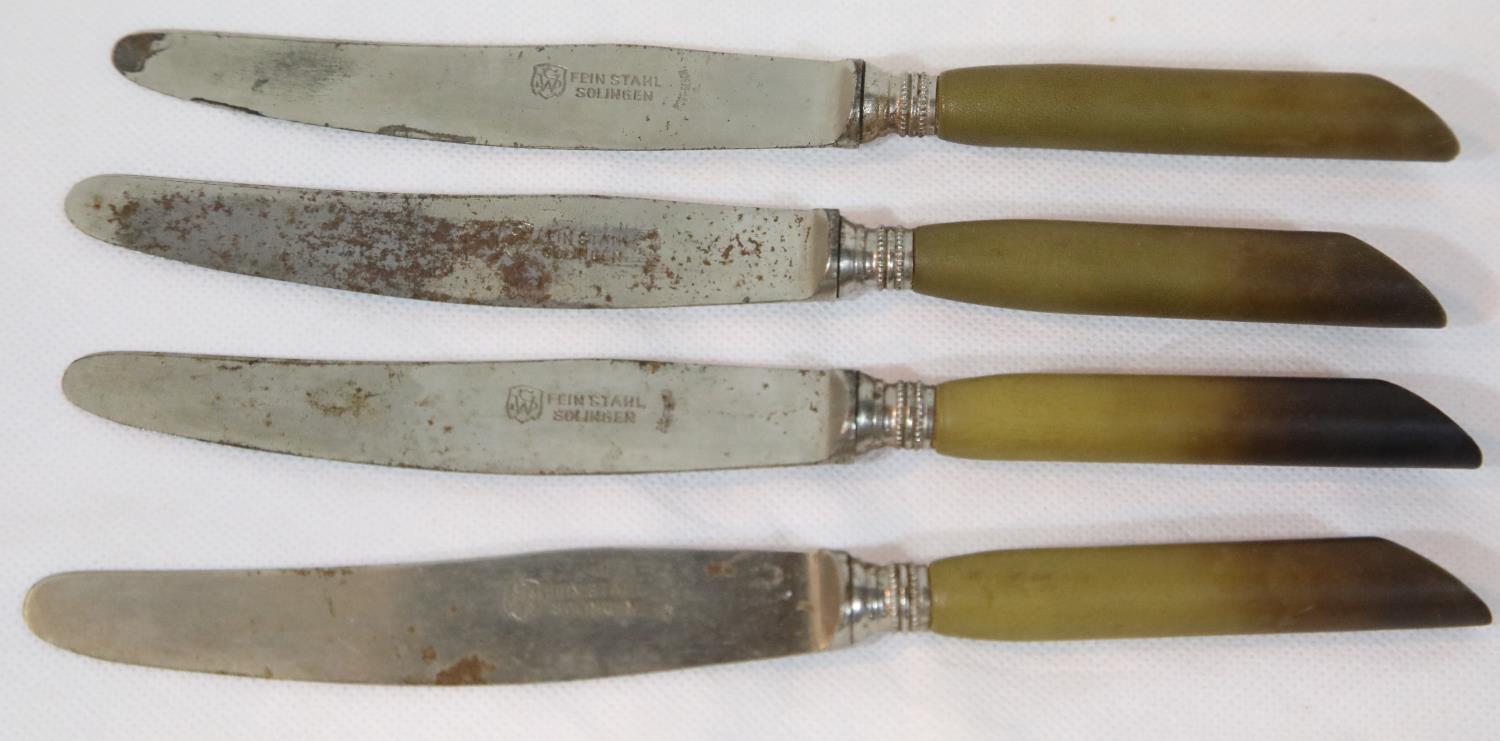 Four German WWII type Waffen SS Horn Handle Dinner Knives. P&P Group 2 (£18+VAT for the first lot