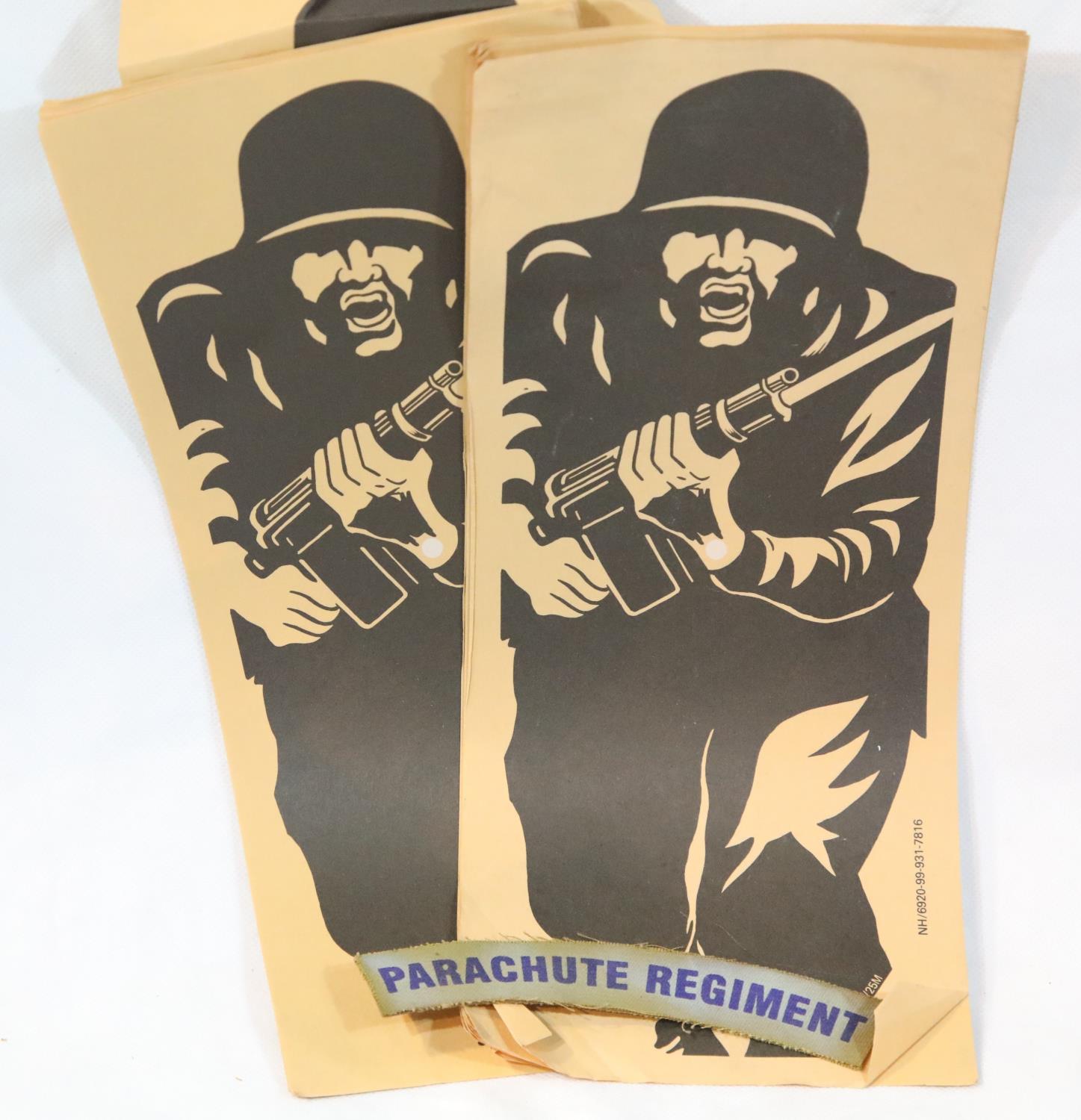 Twenty unused paper rifle targets, and a Parachute Regiment shoulder title. P&P Group 1 (£14+VAT for