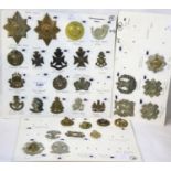 Collection of 31 British cap badges, mounted onto card and annotated. P&P Group 1 (£14+VAT for the