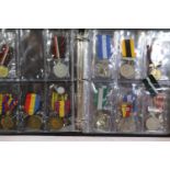 Folder containing a quantity of world medals, mainly military, 25 in total. P&P Group 1 (£14+VAT for