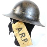 British WWII type ARP black helmet, dated inside 1941, with an ARP armband. P&P Group 2 (£18+VAT for