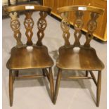 Pair of vintage Ercol chairs with decorative scrolling to backs. Not available for in-house P&P