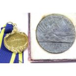 Boxed Lusitania table medal and a reproduction yellow metal RMS Carpathia medal. P&P Group 1 (£14+