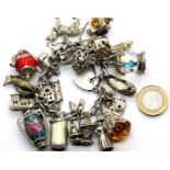 Silver charm bracelet with 25 charms, 130g. P&P Group 1 (£14+VAT for the first lot and £1+VAT for