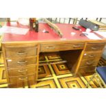 Mid century twin pedestal writing desk with red leather top, the central drawer marked Bullens,