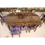 Large extending Chinese teak dining table with two leaves and a set of eight matching chairs with