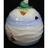 Clarice Cliff covered preserve pot decorated with lilies, H: 11 cm. P&P group 2 (£18+ VAT for the