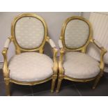 Pair of gilt wood antique arm chairs with upholstered backs and seats in the French manner. Not