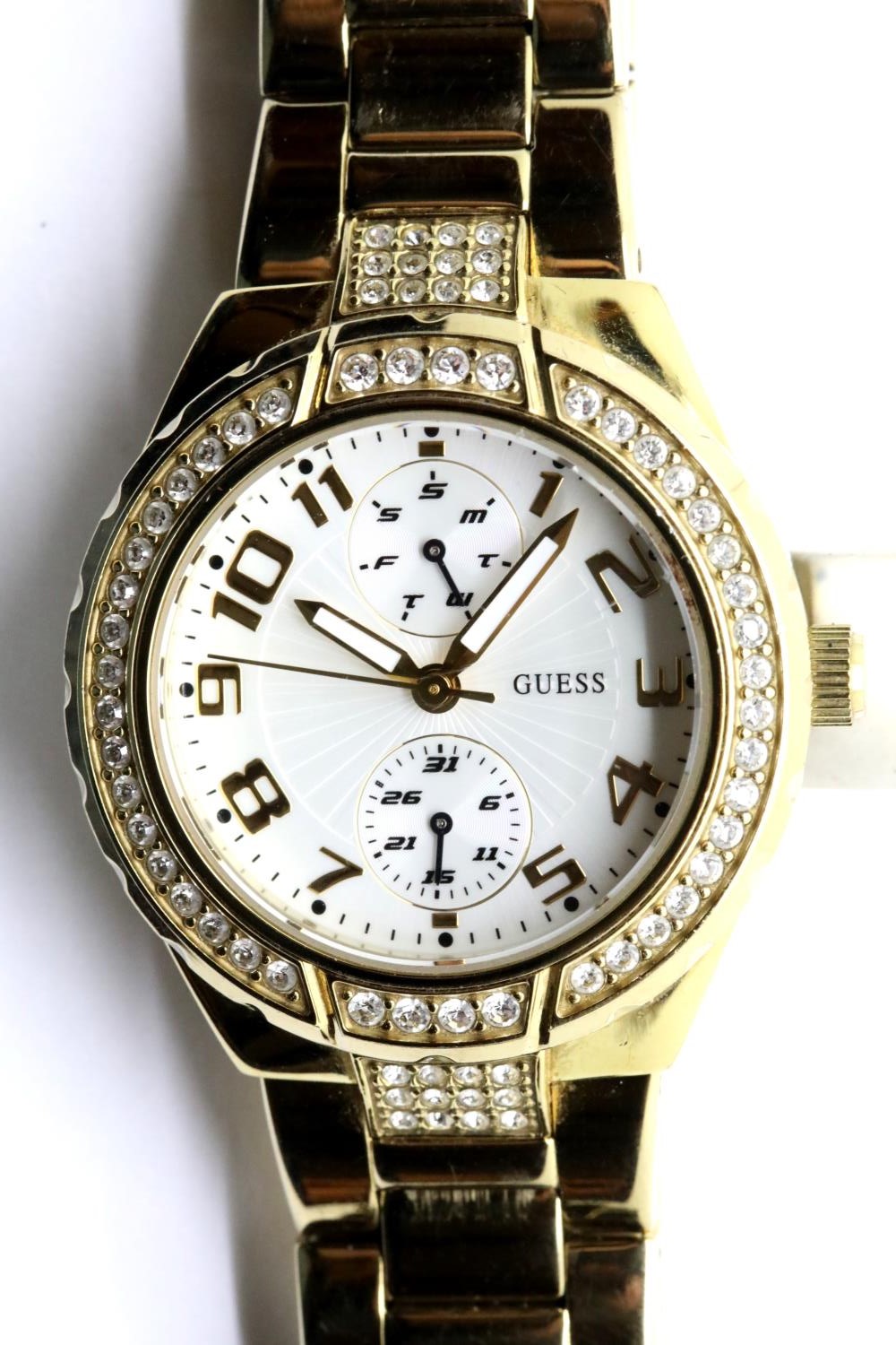 Ladies Guess wristwatch with stone set bezel, new battery fitted. P&P Group 1 (£14+VAT for the first