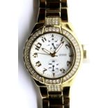 Ladies Guess wristwatch with stone set bezel, new battery fitted. P&P Group 1 (£14+VAT for the first