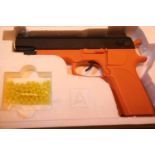 Airsoft 6mm BB gun in orange wrapping. P&P Group 2 (£18+VAT for the first lot and £3+VAT for