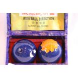 Pair of oriental iron directional balls. Not available for in-house P&P