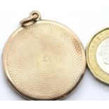 Presumed 9ct gold circular locket with machine turned decoration, unmarked, D: 31 mm, 10.7g. P&P