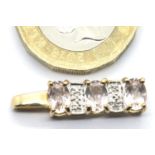 Presumed 9ct gold pendant set with three stones, L: 24 mm, 1.5g. P&P Group 1 (£14+VAT for the