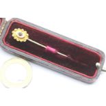 15ct gold stick pin set with a single sapphire, on a gold plated pin, in its original velvet lined