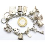 Silver charm bracelet with ten charms, 40g. P&P Group 1 (£14+VAT for the first lot and £1+VAT for